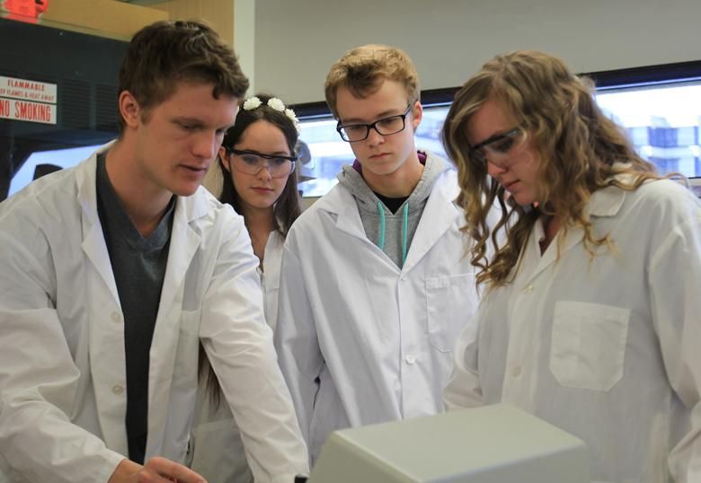 Students don lab coats during the fourth annual Let’s DO Science Day