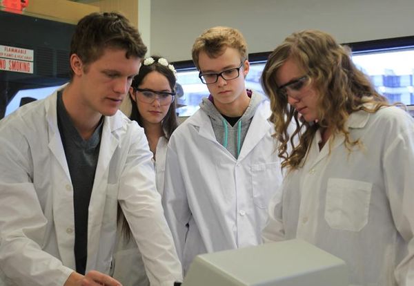 Students don lab coats during the fourth annual Let’s DO Science Day