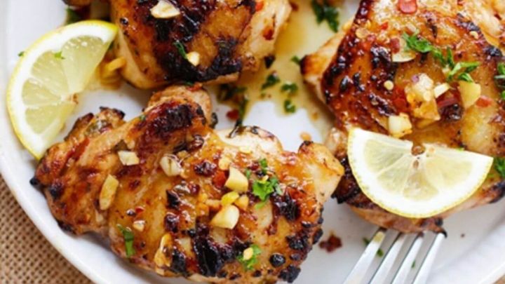 Zesty lemon garlic chicken pieces in a baking dish