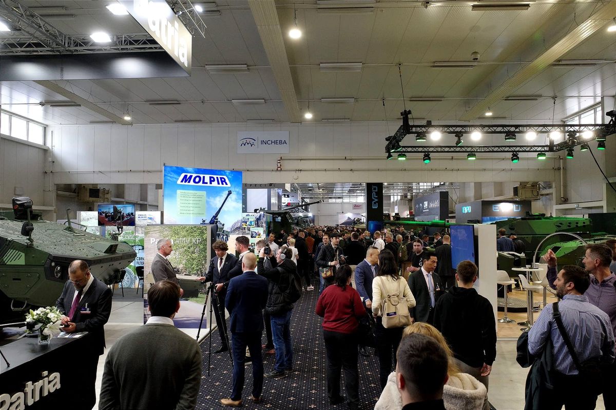Visitors walk through the exhibition hall during the IDEB 2026 defense and security fair in Bratislava.