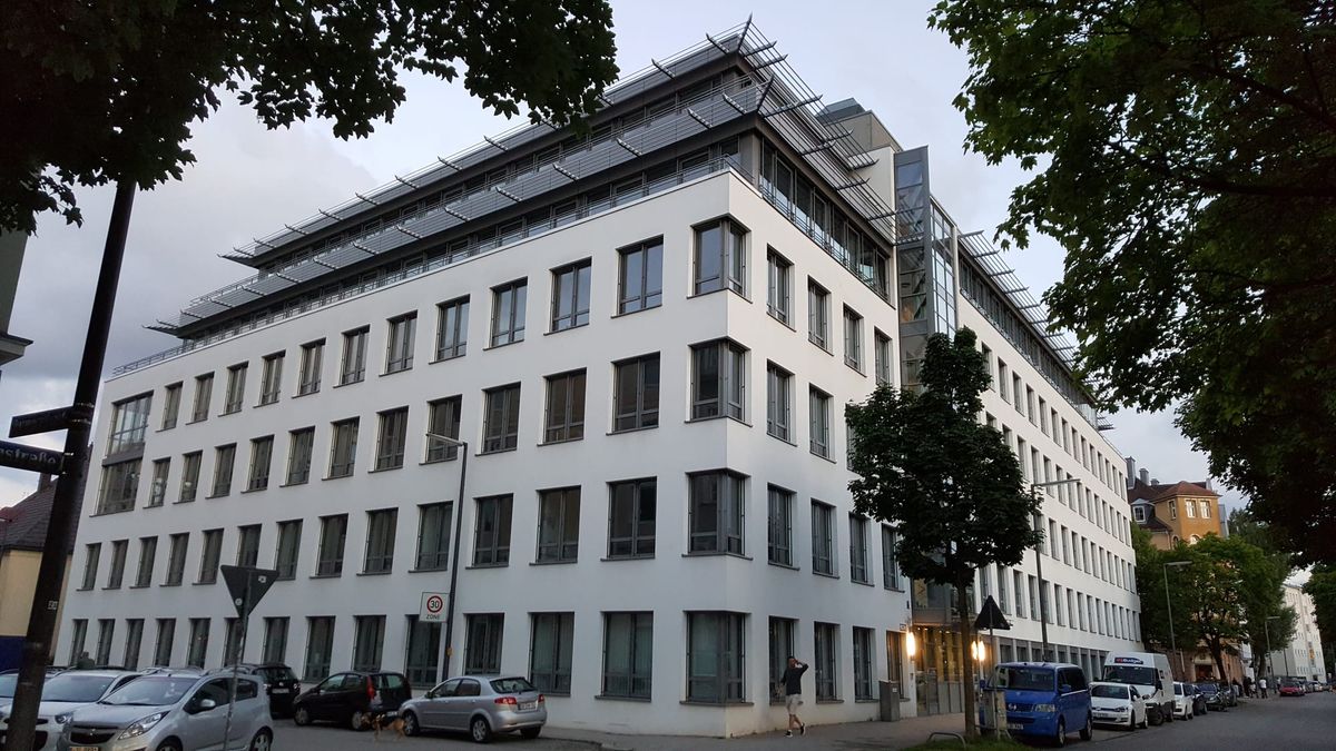 Rohde & Schwarz office building on Friedenstraße in Munich, photographed at dusk. 