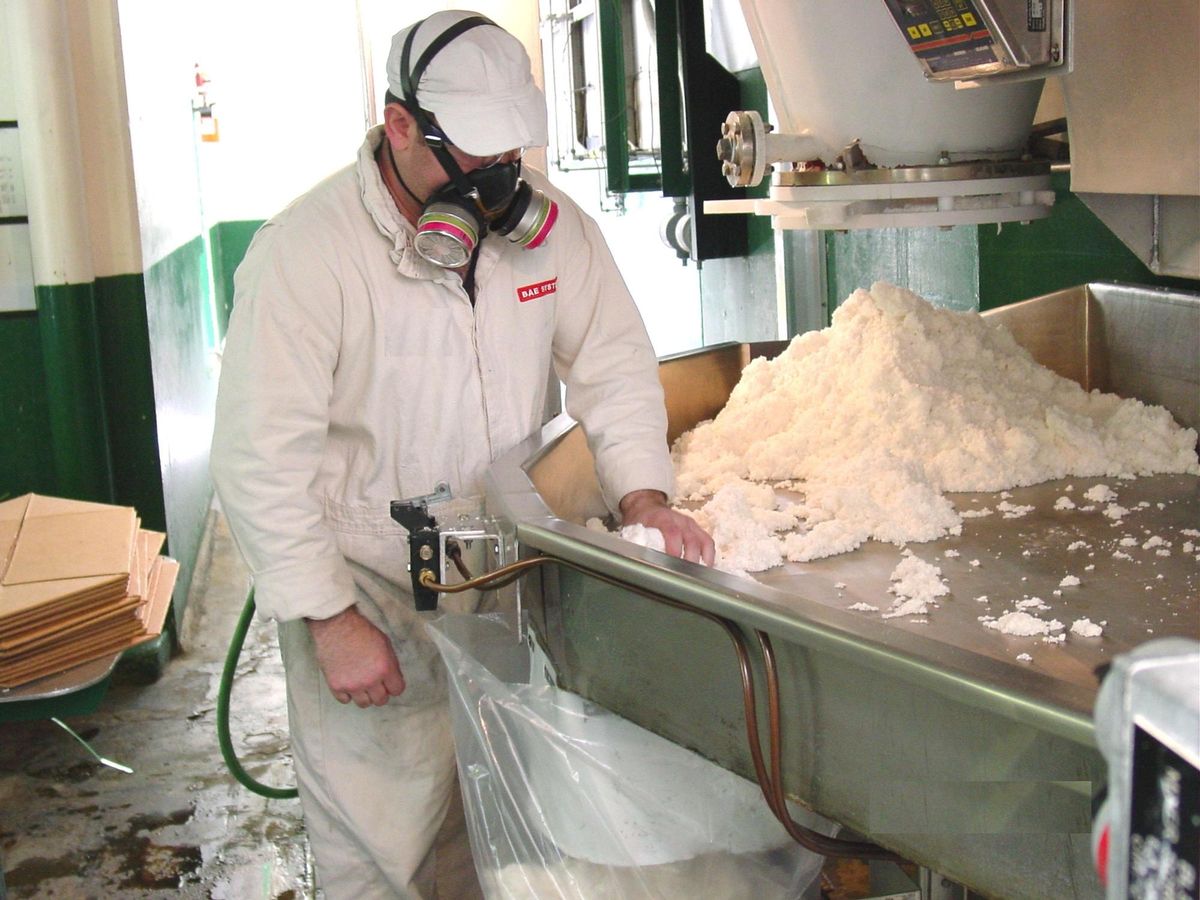 Worker handling military explosives at the U.S. Army’s Holston Ammunition Plant, which produces RDX.