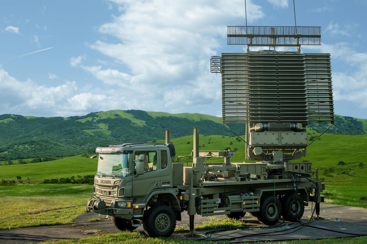 Lockheed Martin AN/TPS-77 mobile air surveillance radar mounted on a military truck with its antenna raised.