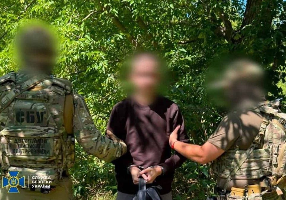 SBU officers detaining a suspected Russian intelligence agent accused of exposing Ukrainian drone unit positions.