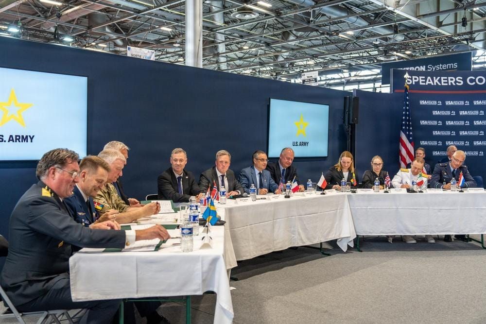 Military and government representatives sign agreements during the U.S. Army's UAS and Counter-UAS Marketplace ceremony at AUSA 2026 in Washington.