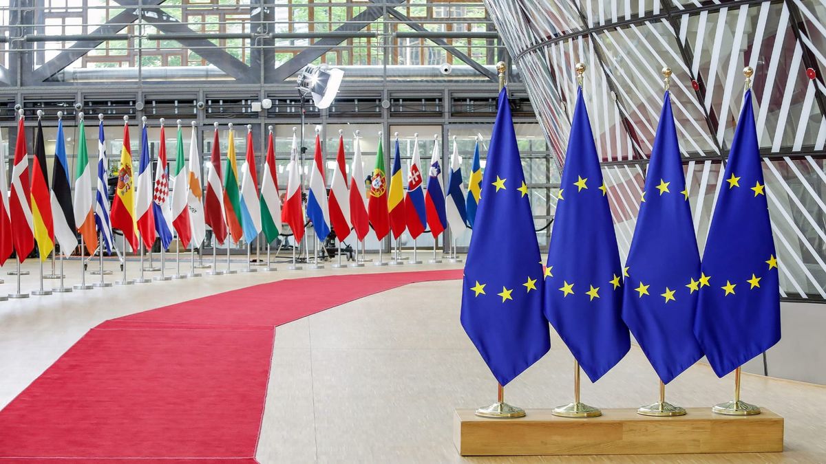 European Union and member state flags inside the Council of the EU's Europa building in Brussels.