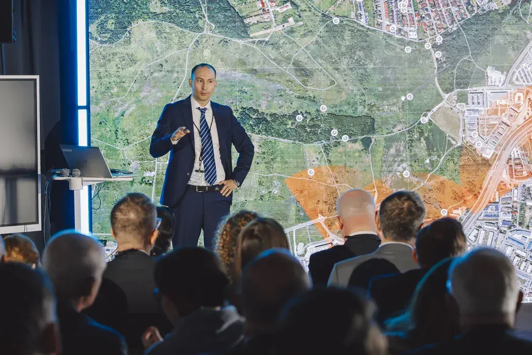 Quadcopter drone flying over an urban area in footage accompanying a Polish drone detection technology demonstration.
