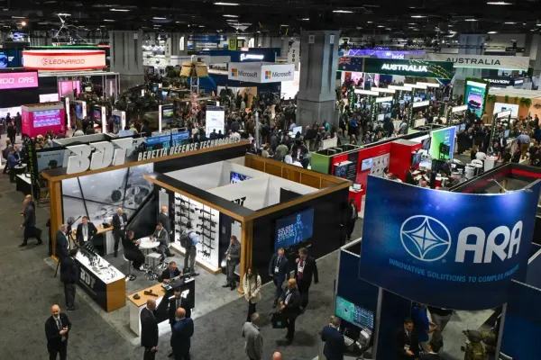 Defense industry exhibitors and attendees on the exhibition floor at AUSA 2025 in Washington, D.C.