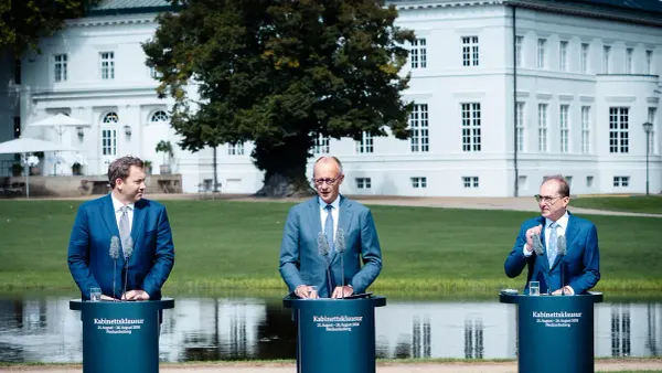 German Interior Minister Alexander Dobrindt speaking at an outdoor press conference in Neuhardenberg.