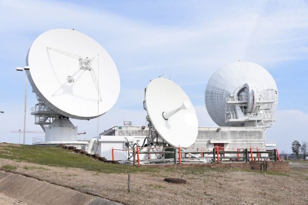 U.S. Army satellite communications ground station with large parabolic antennas.
