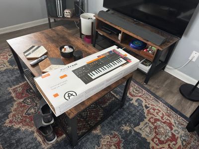 An unboxed Arturia Minifreak on the coffee table