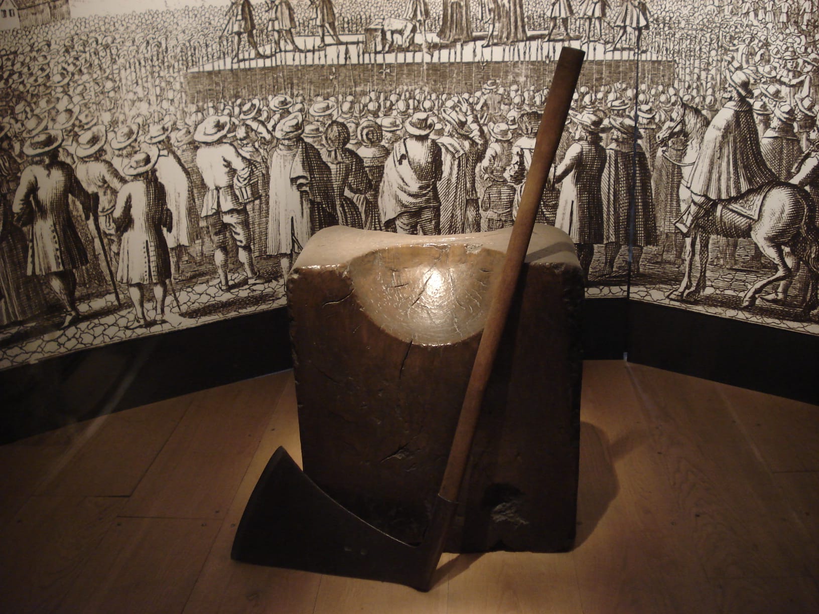 Historic execution block with an axe in a museum setting