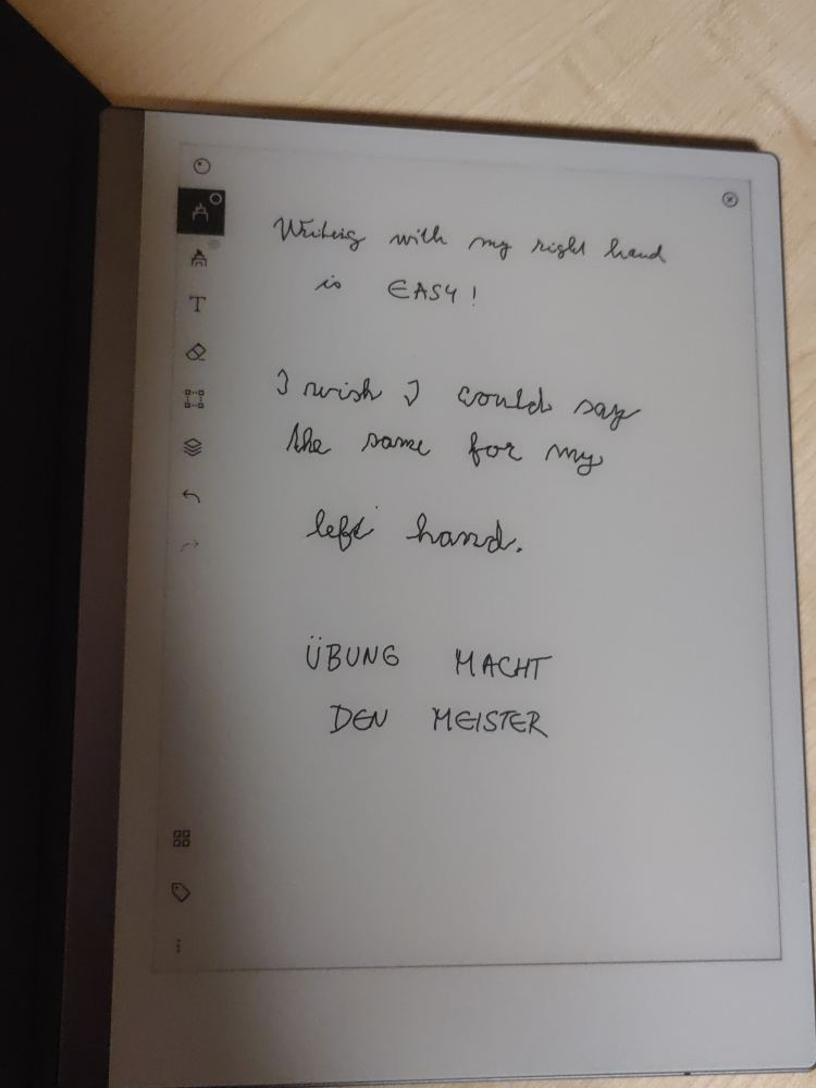 Photo of a reMarkable tablet displaying handwritten text written with both right and left hands during handwriting practice and embodiment training.