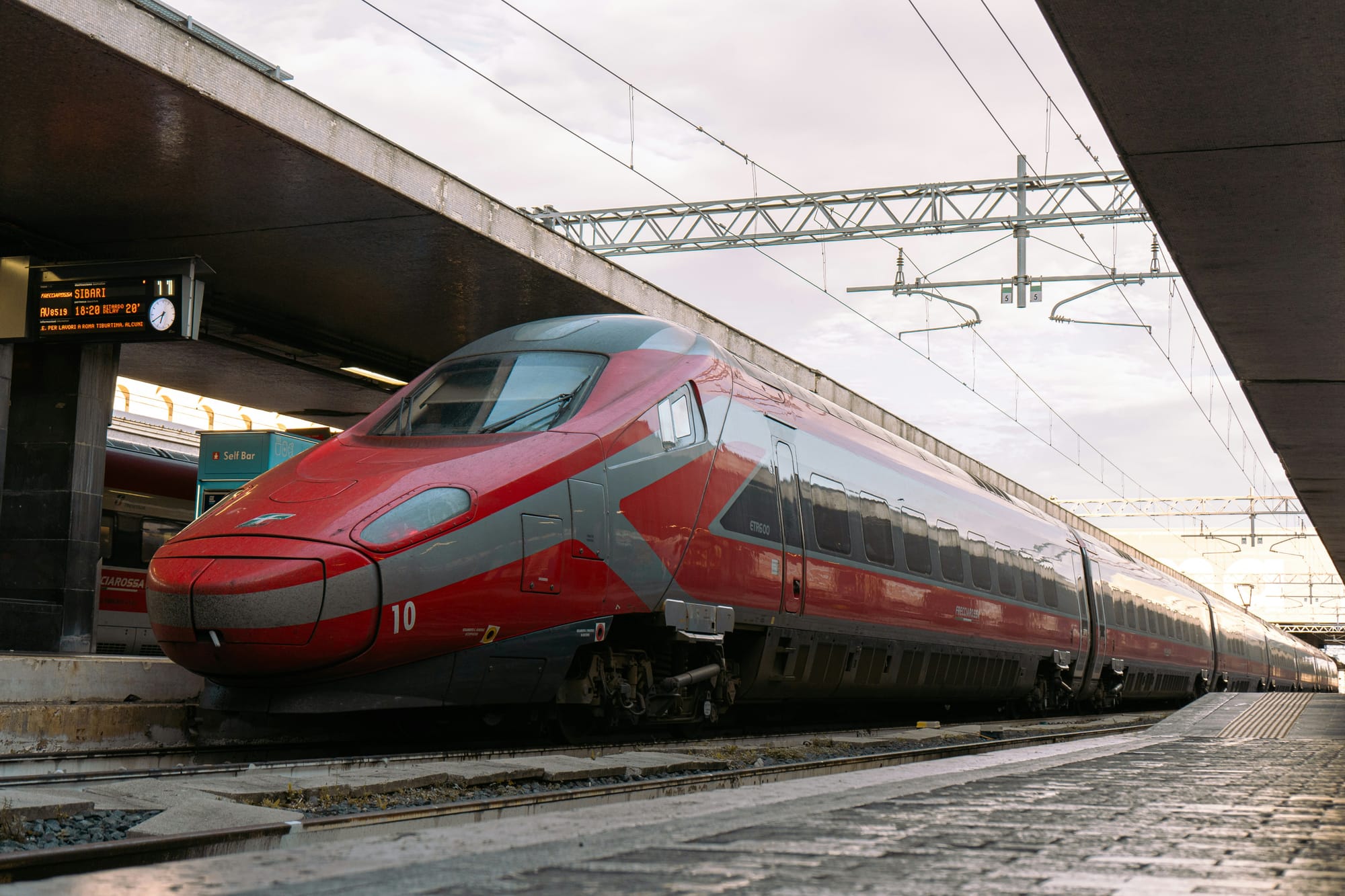 Frecciarossa high-speed train waiting at an Italian railway station.