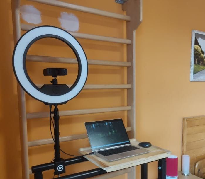 A homemade standing desk built from dip bars and a wooden board, demonstrating how the room was gradually transformed into a multifunctional studio.