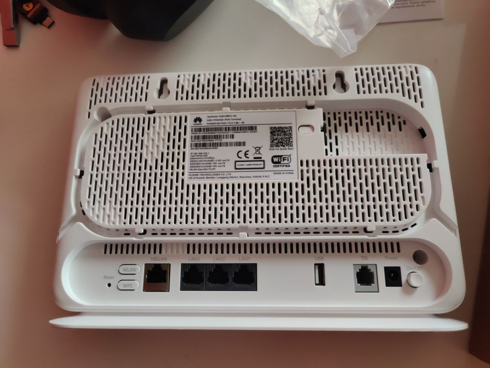 Back side of a white fiber optic terminal/router showing Ethernet ports, including a 10G LAN port, after a home fiber upgrade.