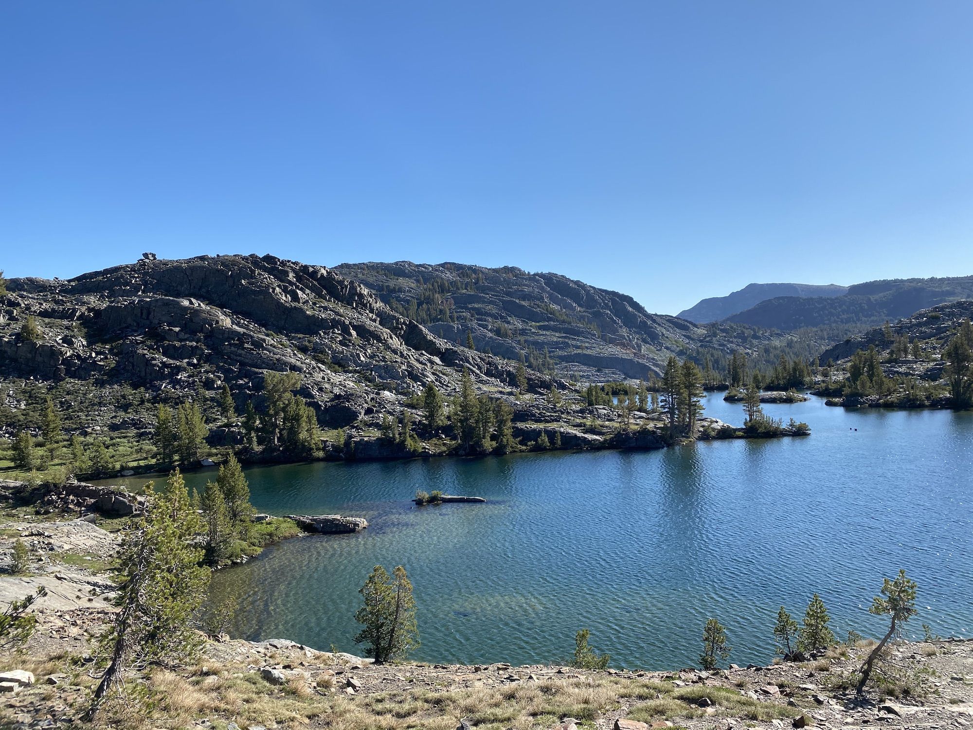 An alpine lake nested between tall rocky mountains