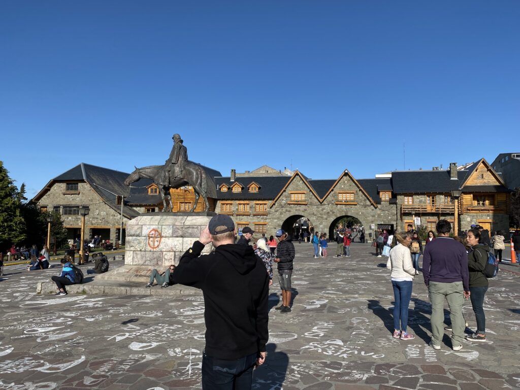 Town square with a statue and alp-style buildings