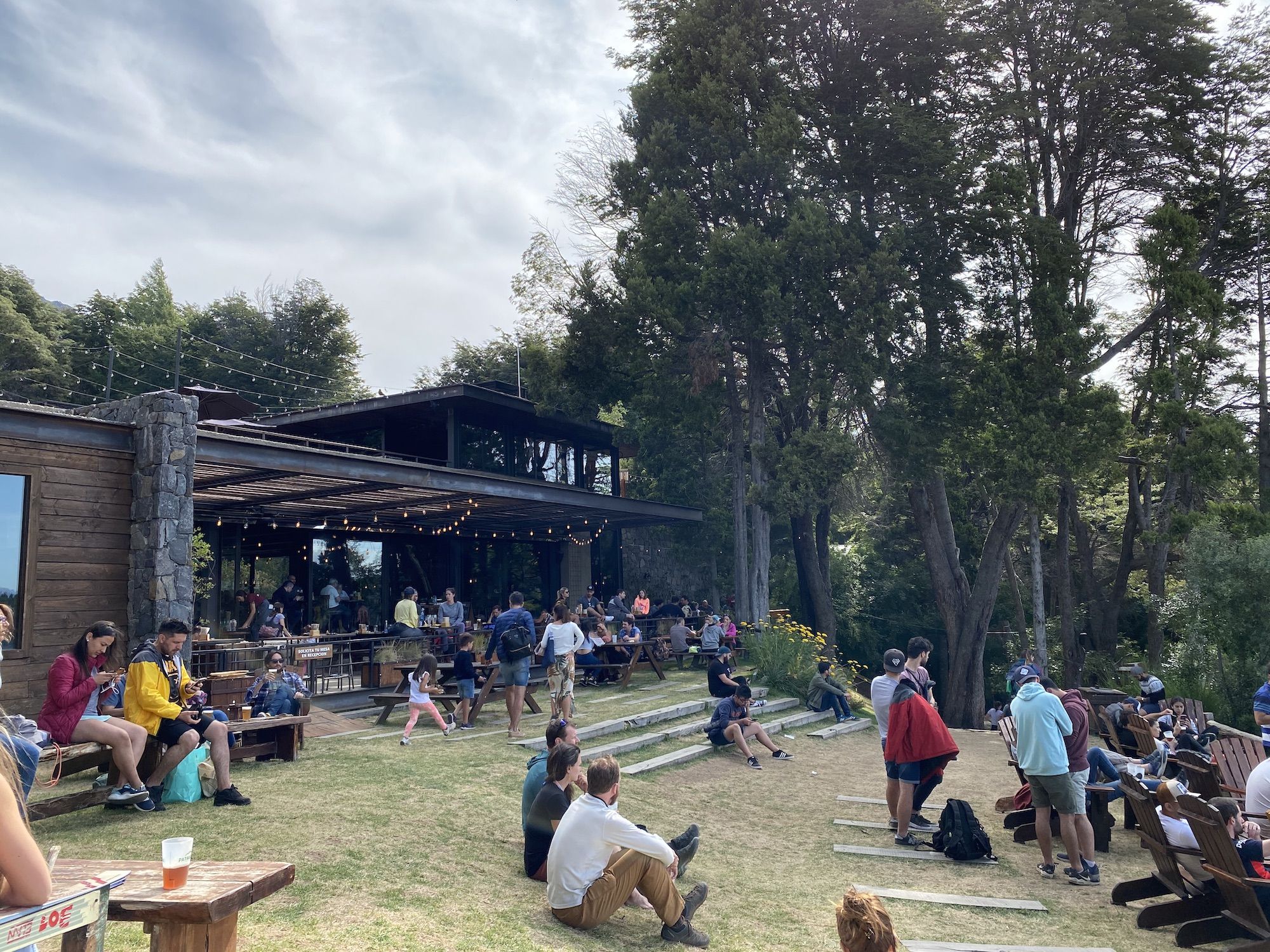 Lawn with lots of people sitting and drinking beer