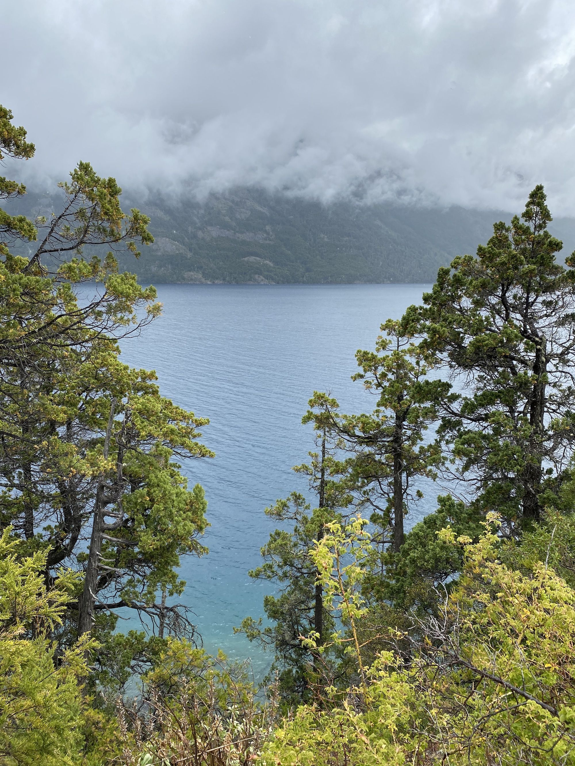 A blue lake with low cloud cover