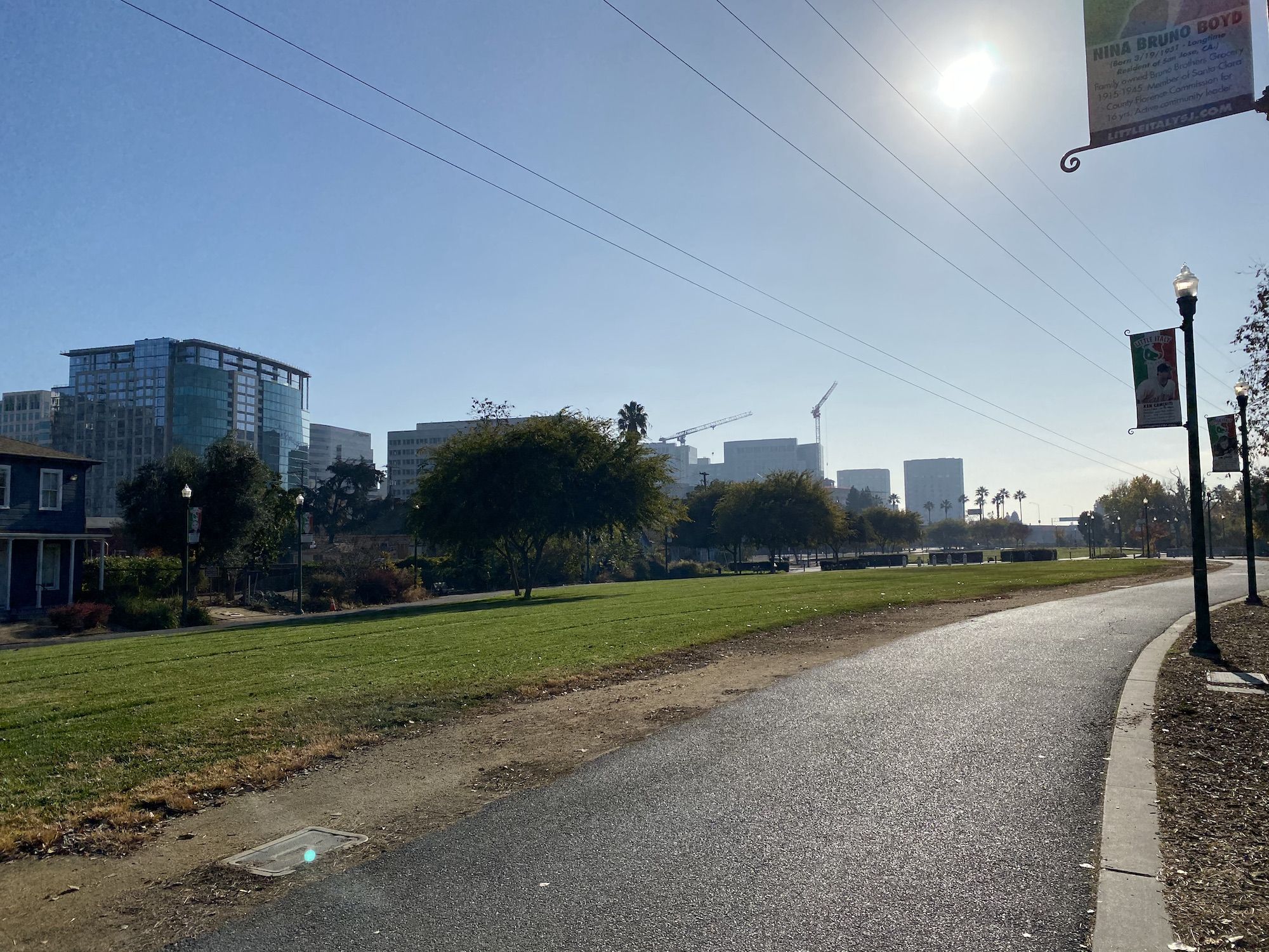 A bike path with tall buildings in the distance.