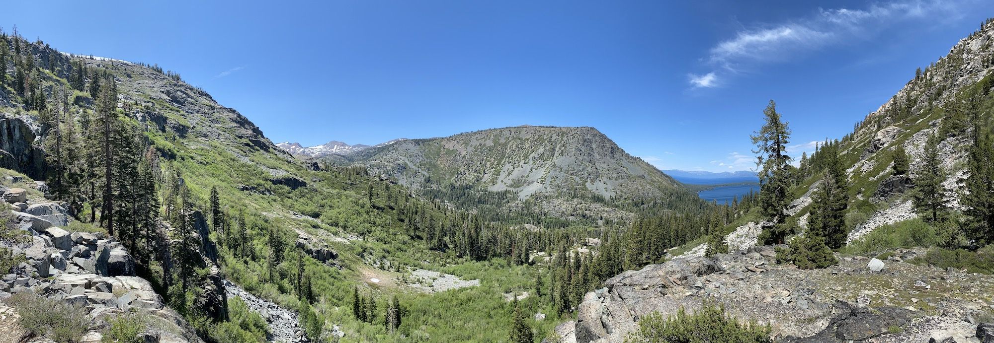 A view of a valley with two lakes in the distance