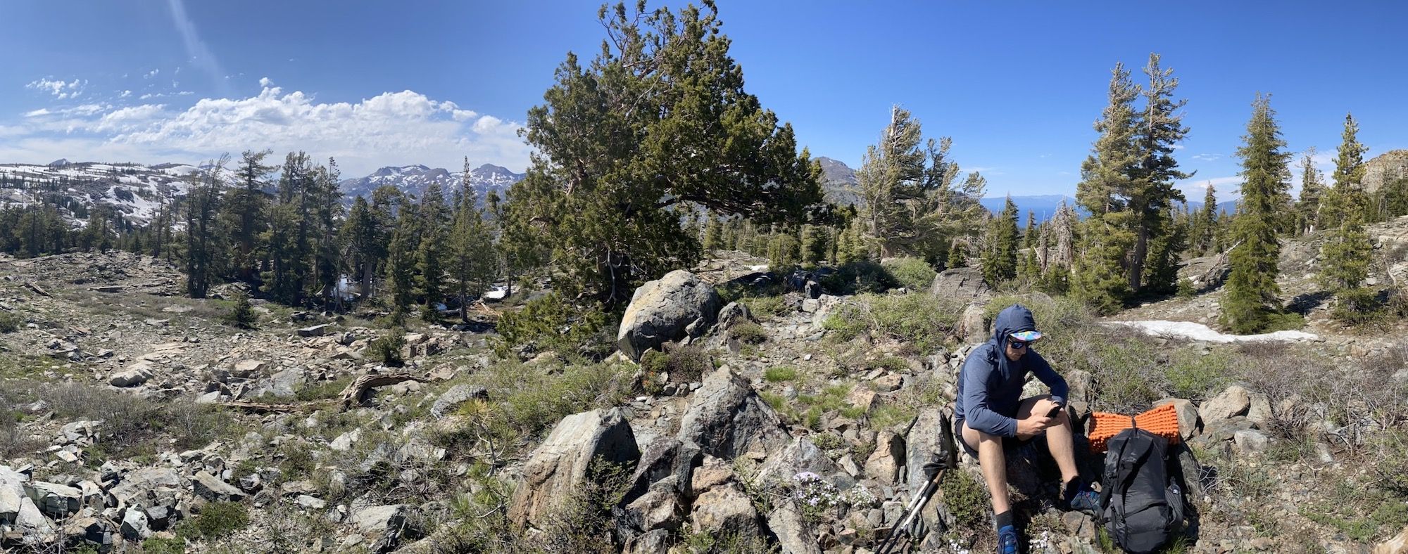 A man sitting on top of a mountain pass