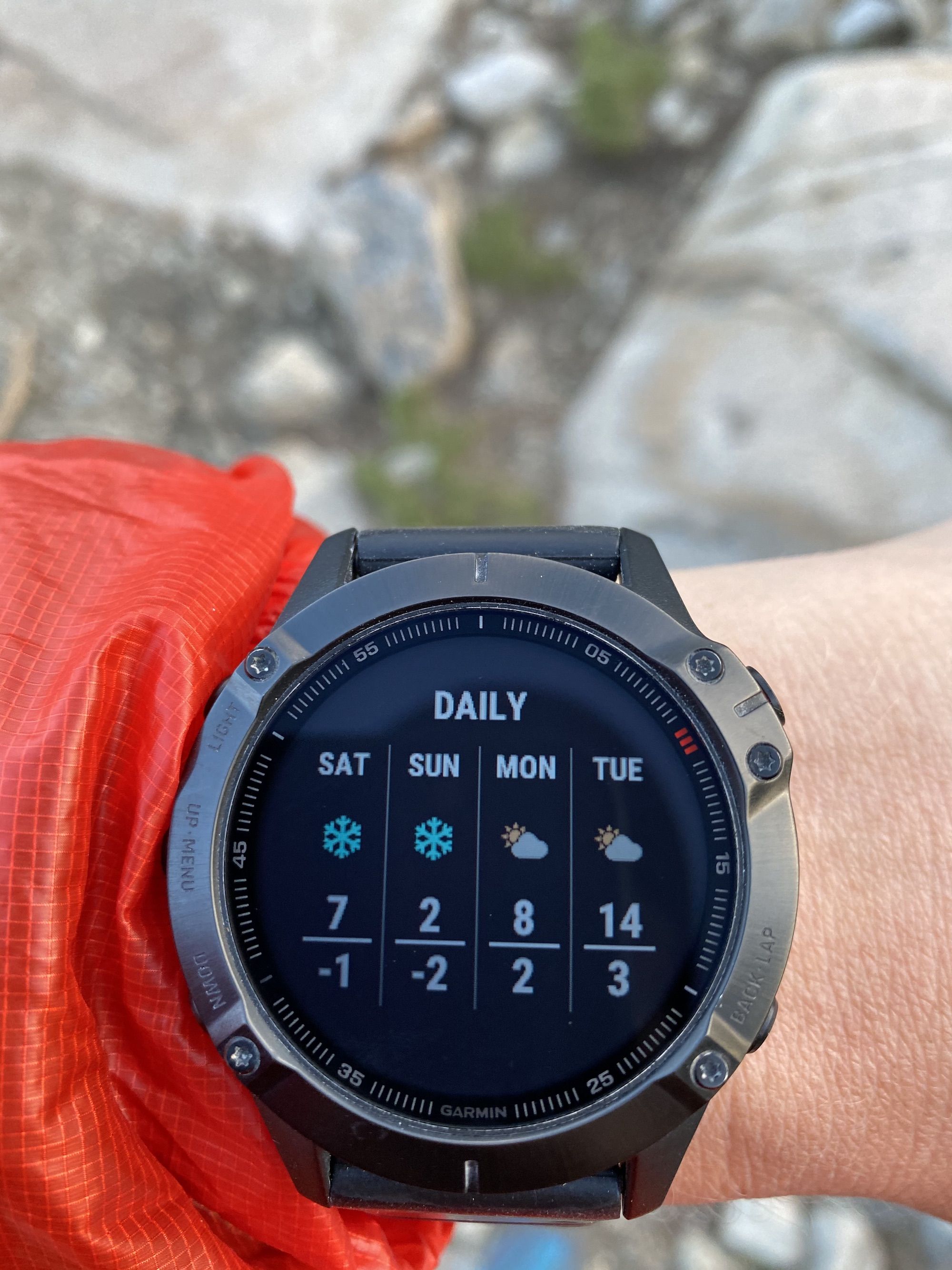 A watch showing a weather forecast with low temperatures and snow.