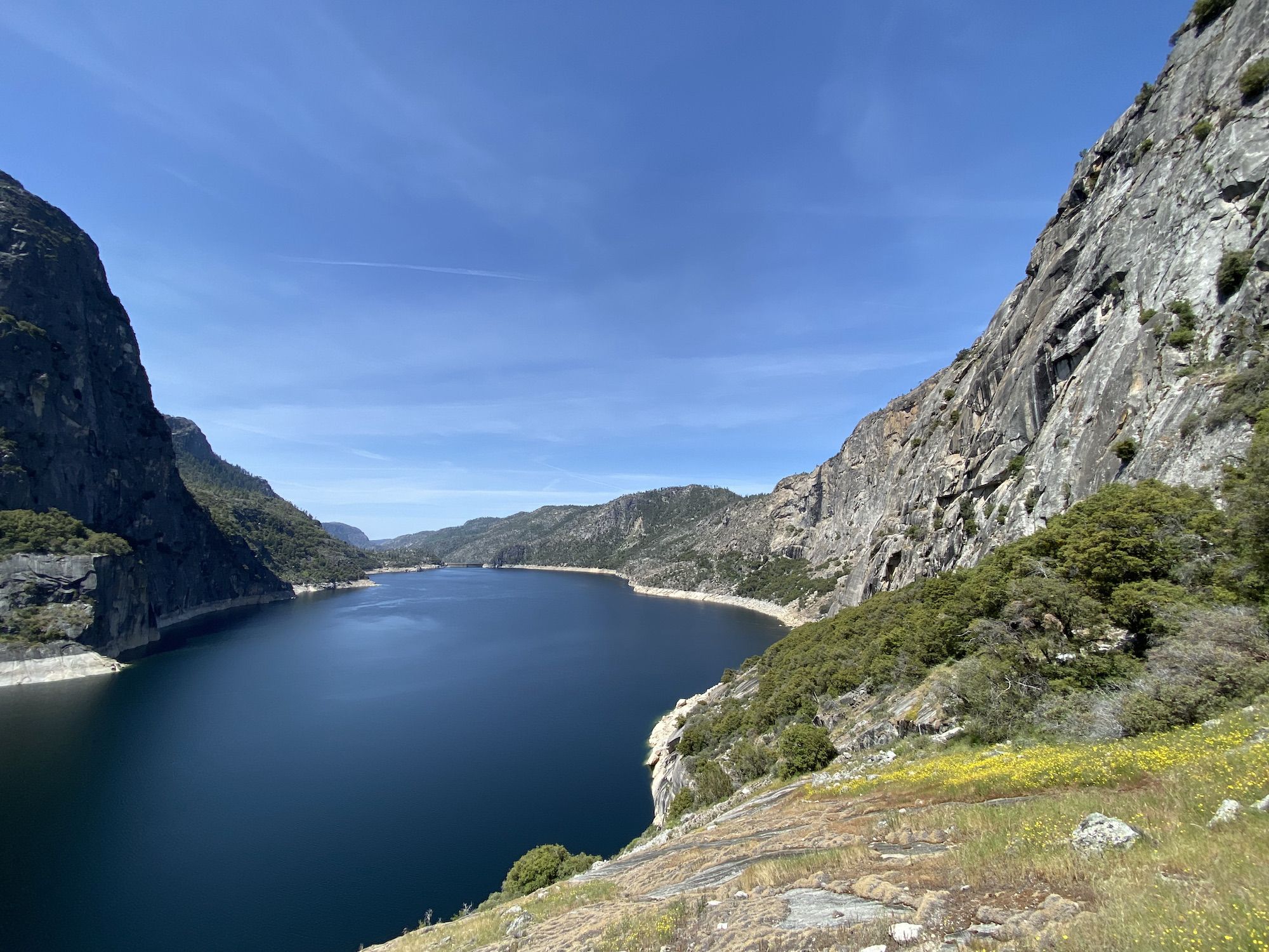 A deep-blue lake surrounded by tall rock walls. 