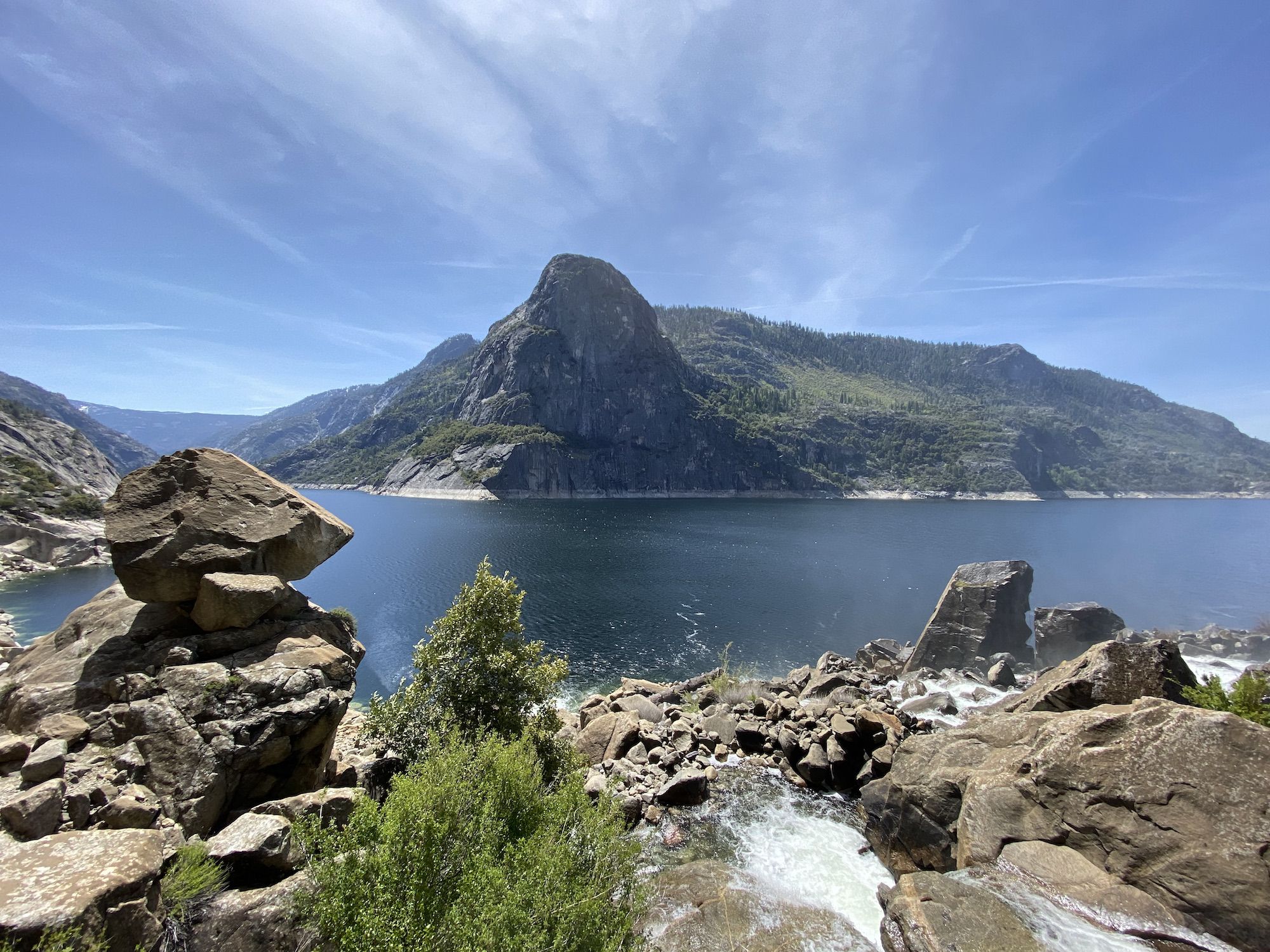 A large granite dome on the other side of a lake. 
