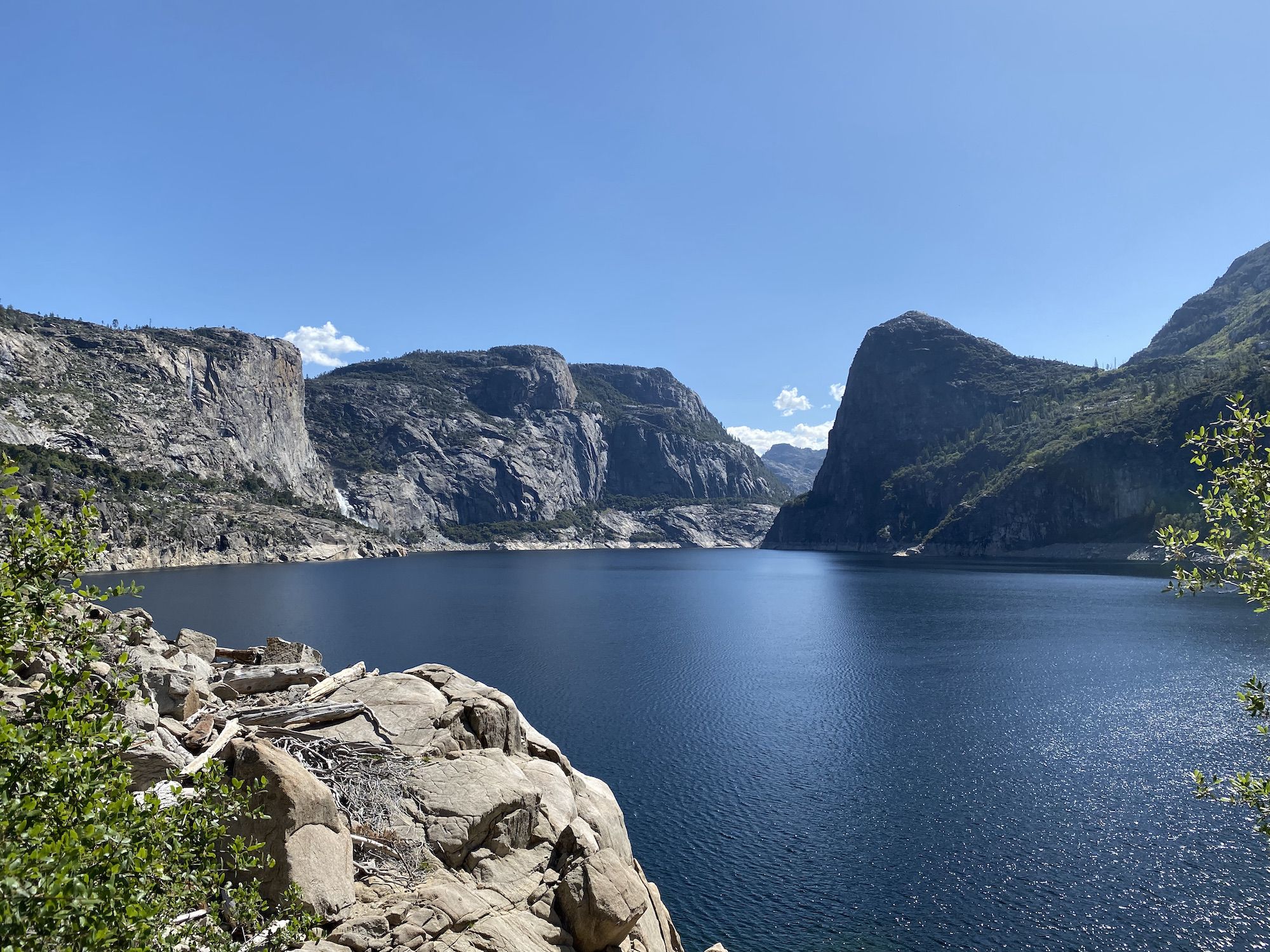 Tall granite walls surrounding a blue lake. 