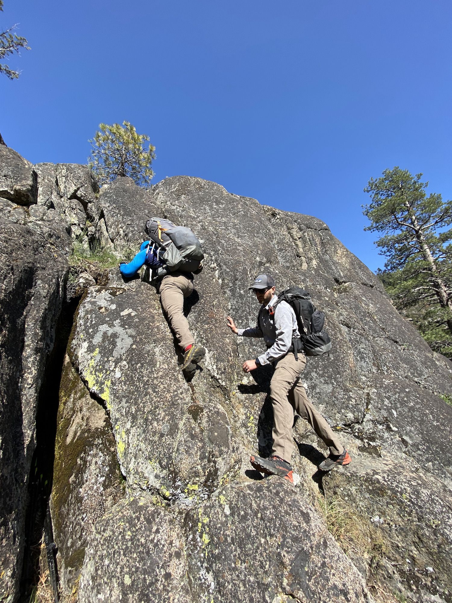 A man climbing down a cliff