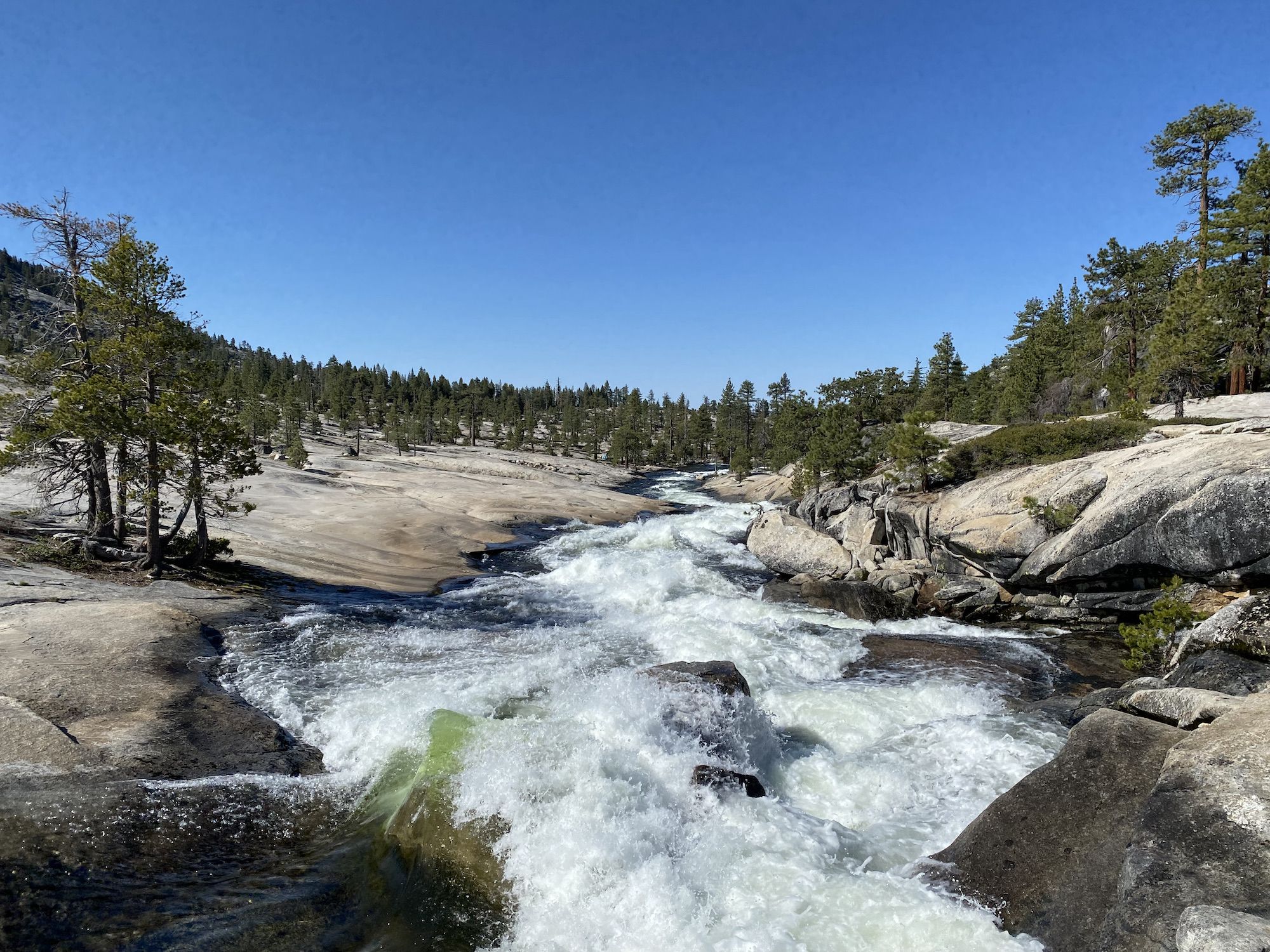 A creek flowing strongly over granite.