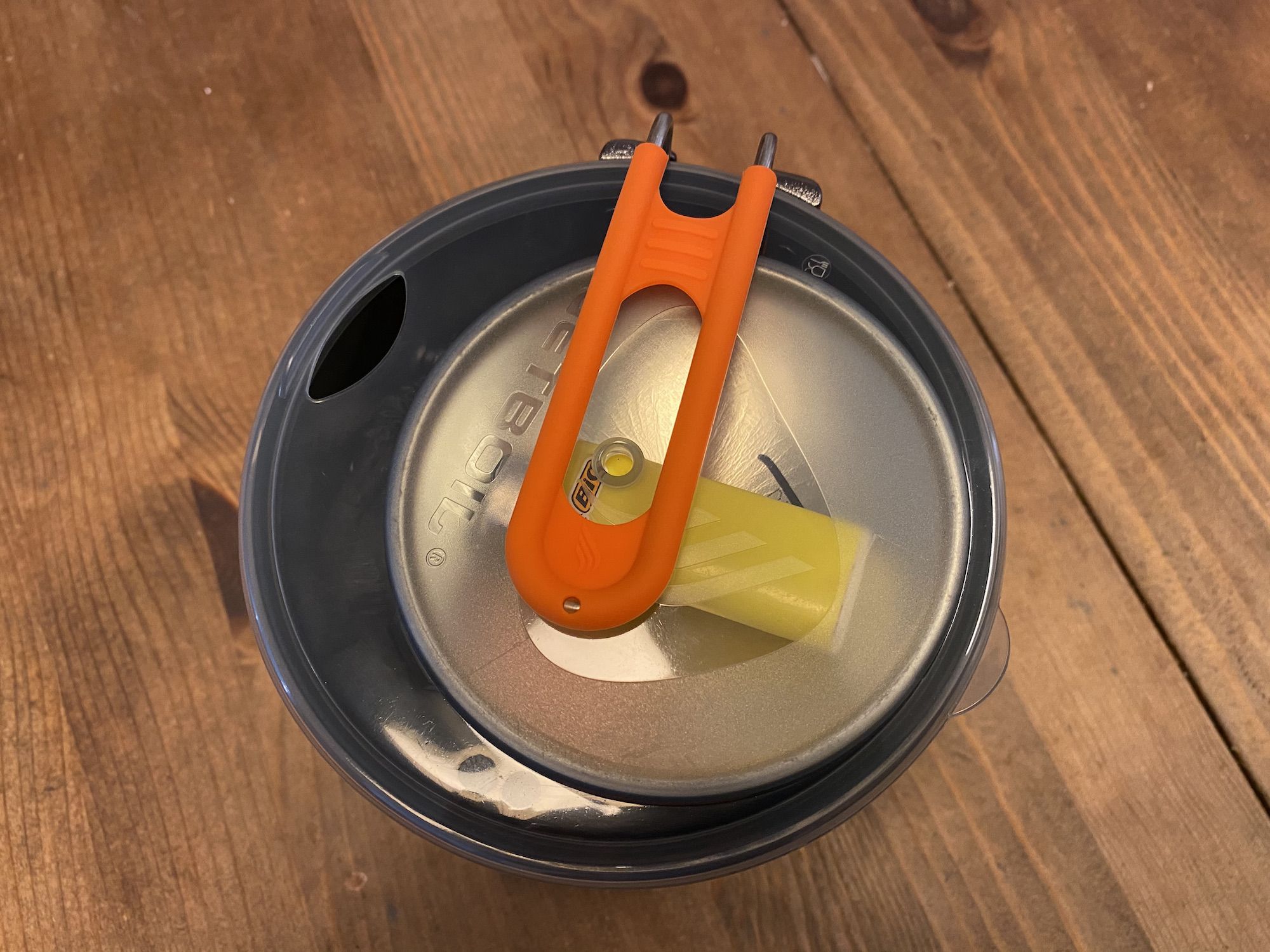 The Jetboil Stash lid holds a  100g fuel canister and a lighter