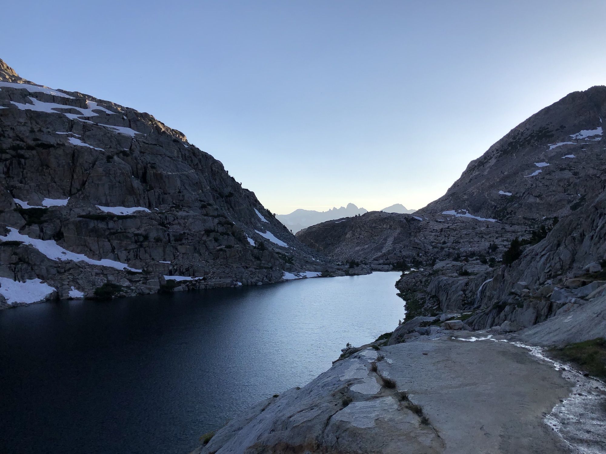 A lake surrounded by bare granite mountains