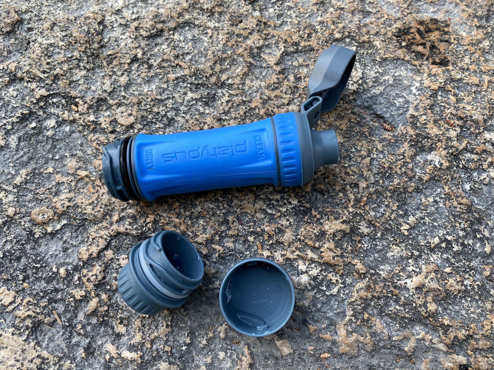 Platypus QuickDraw with the top cap open. The bottom cap and water reservoir caps are below it.