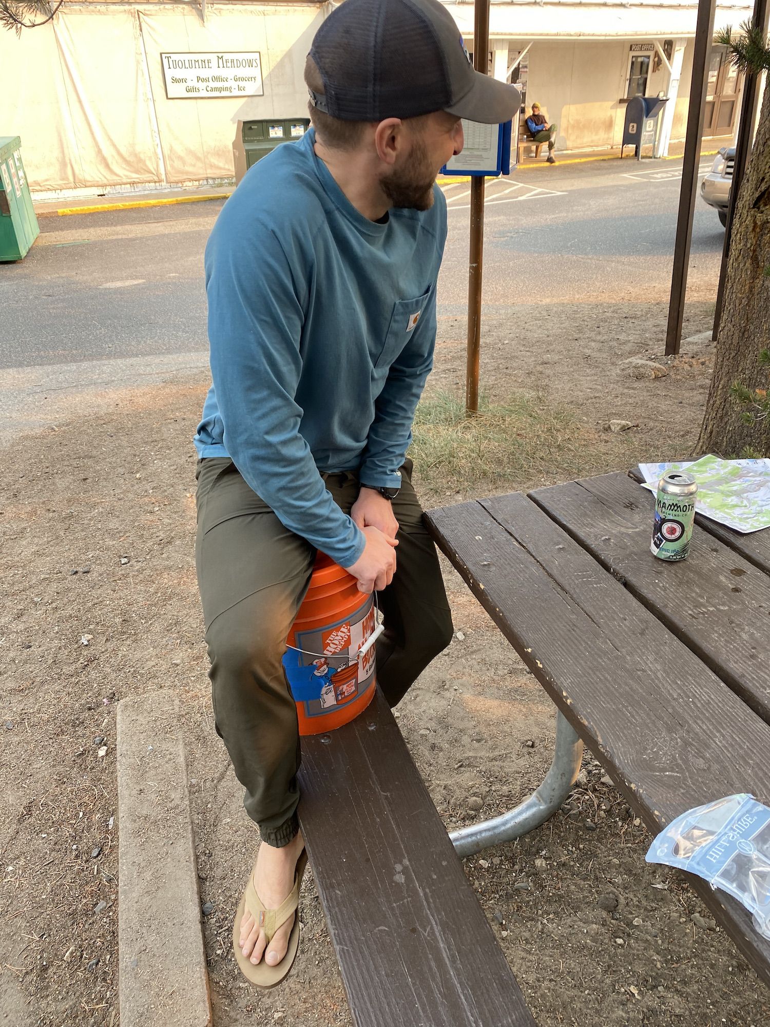 Man sitting on a 5-gallon bucket