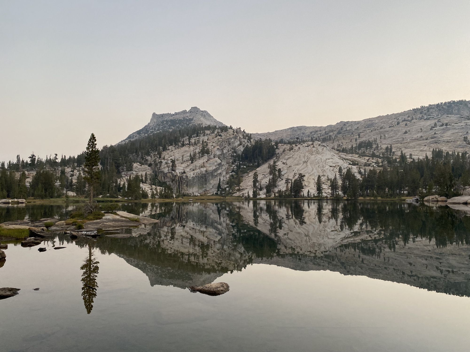 A gray sky over a calm lake. 