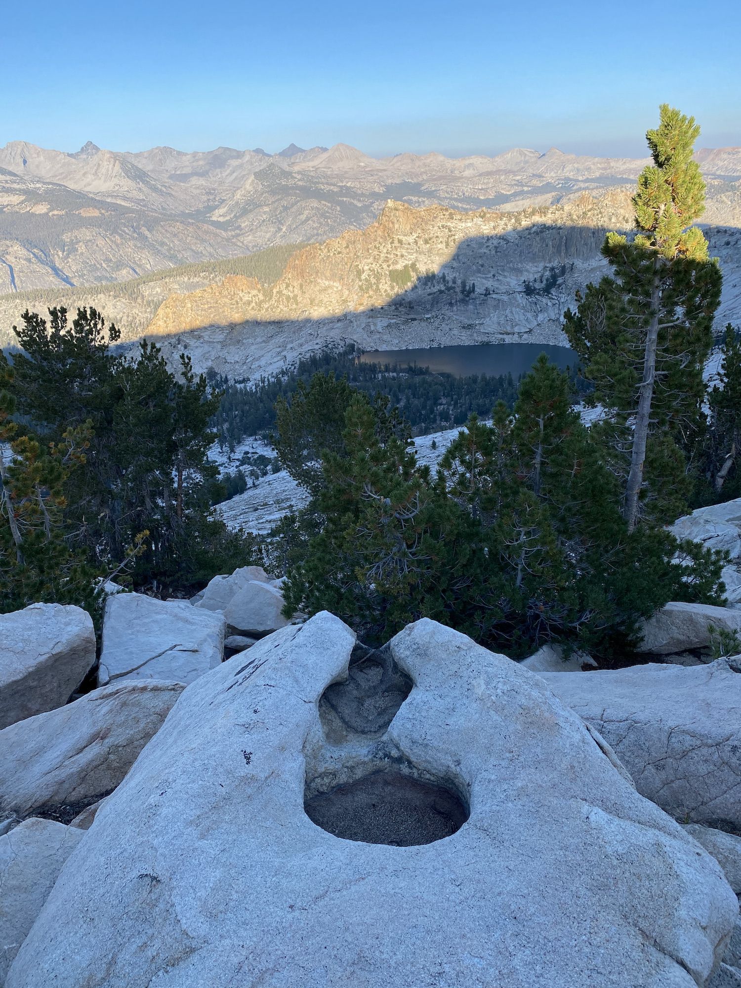 A boulder with two round holes carved by glaciers.