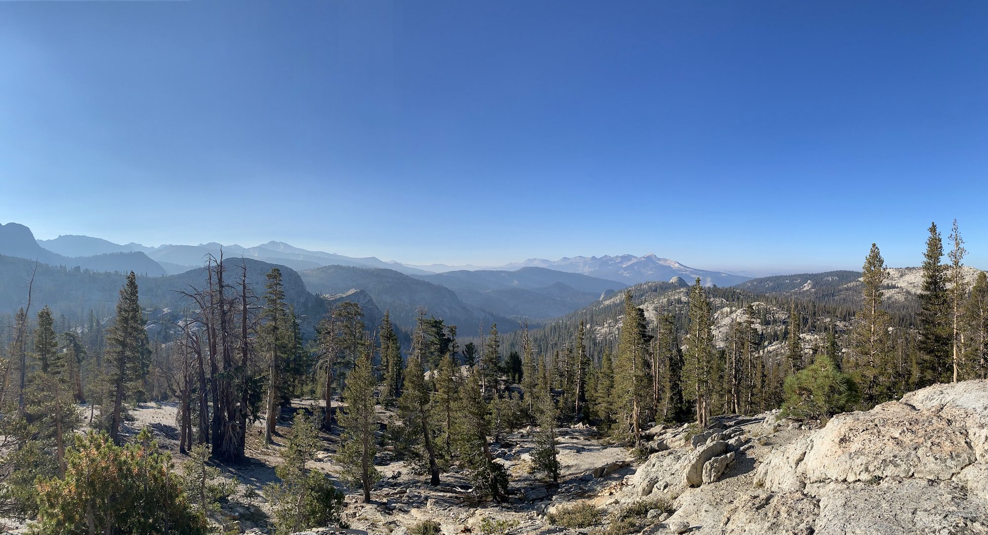 A wide-open mountain landscape with several peaks in the distance.