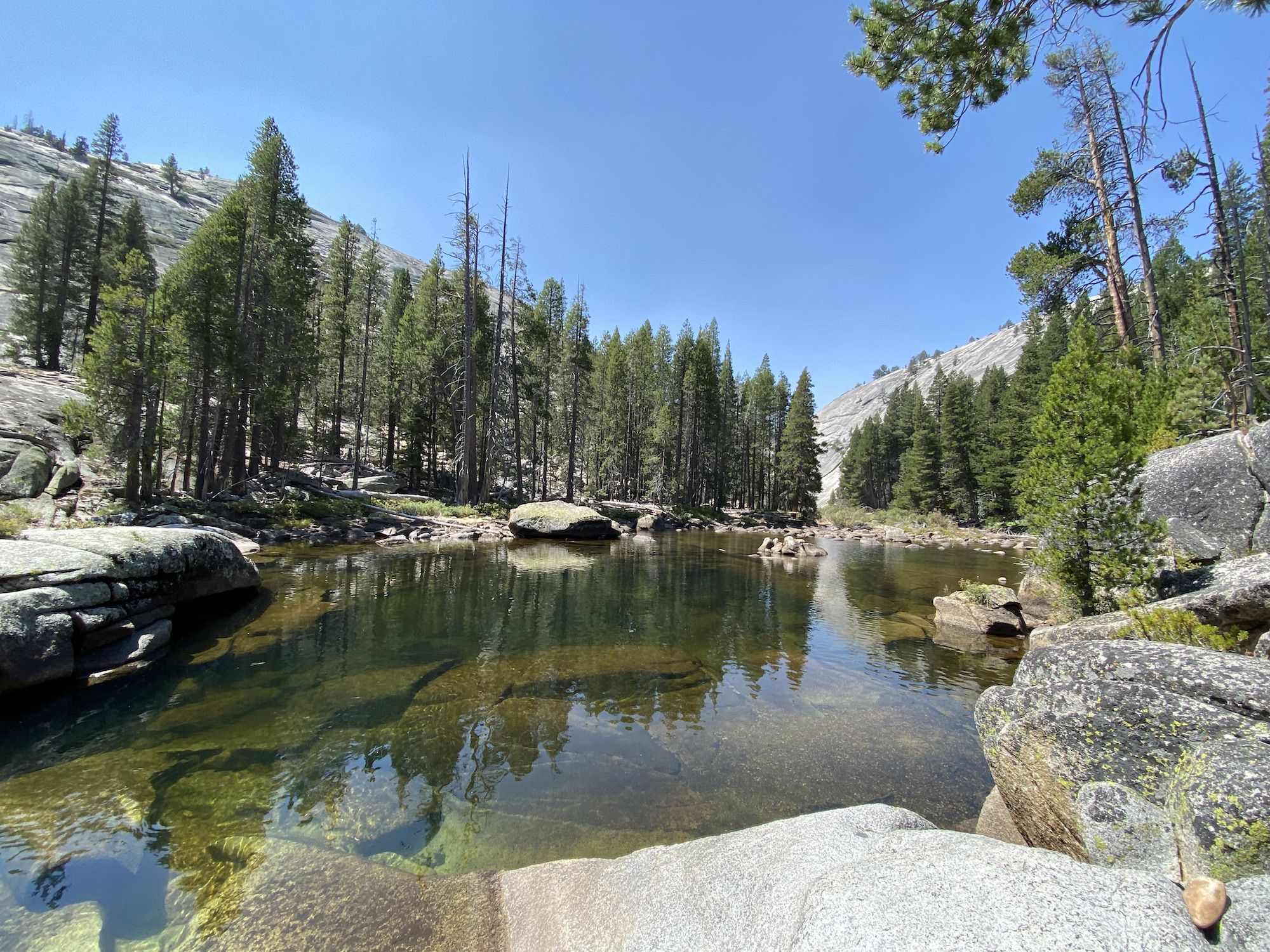 A deep pool surrounded by large rocks.