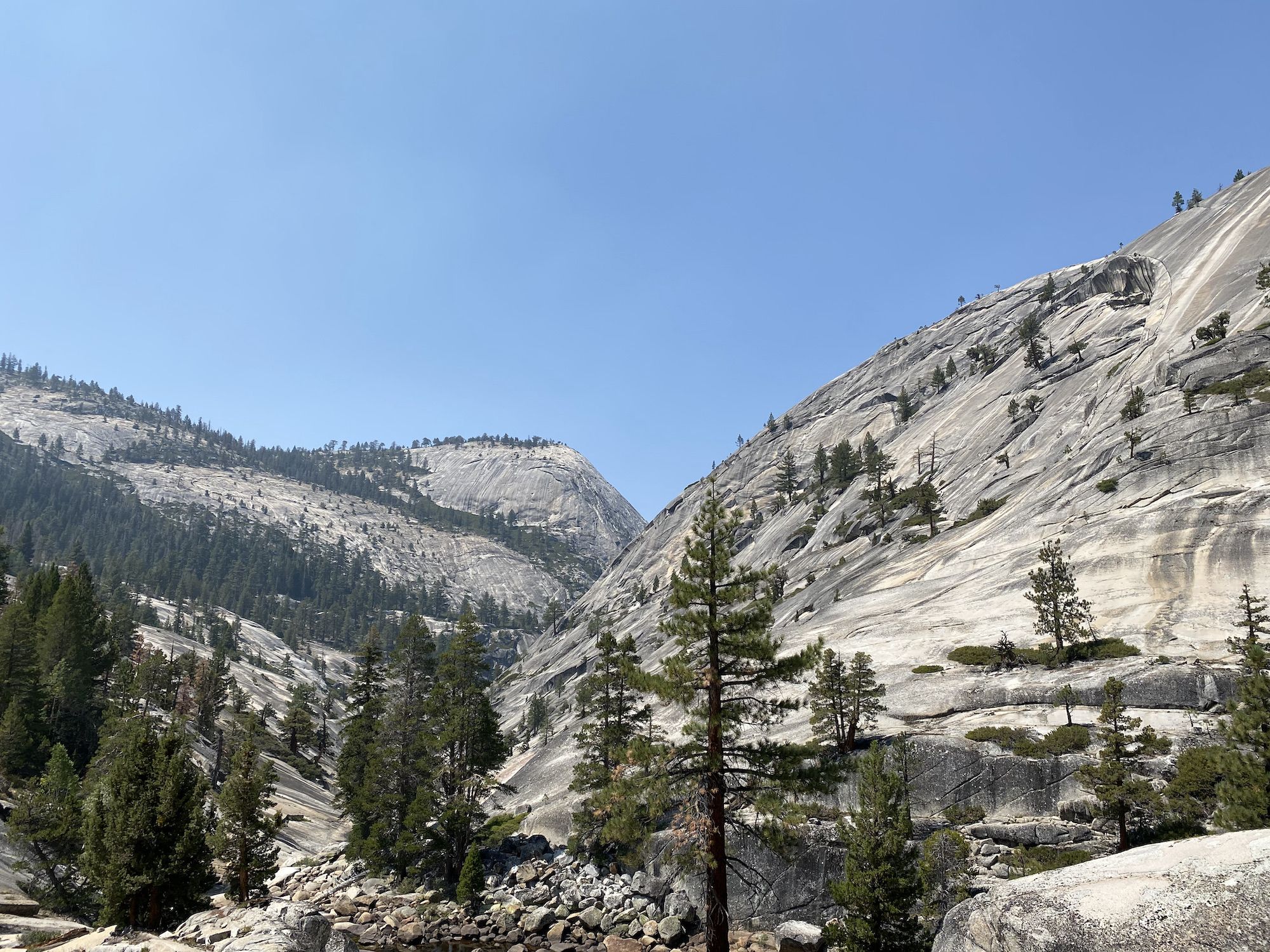 Bare granite mountains making up a narrow valley.