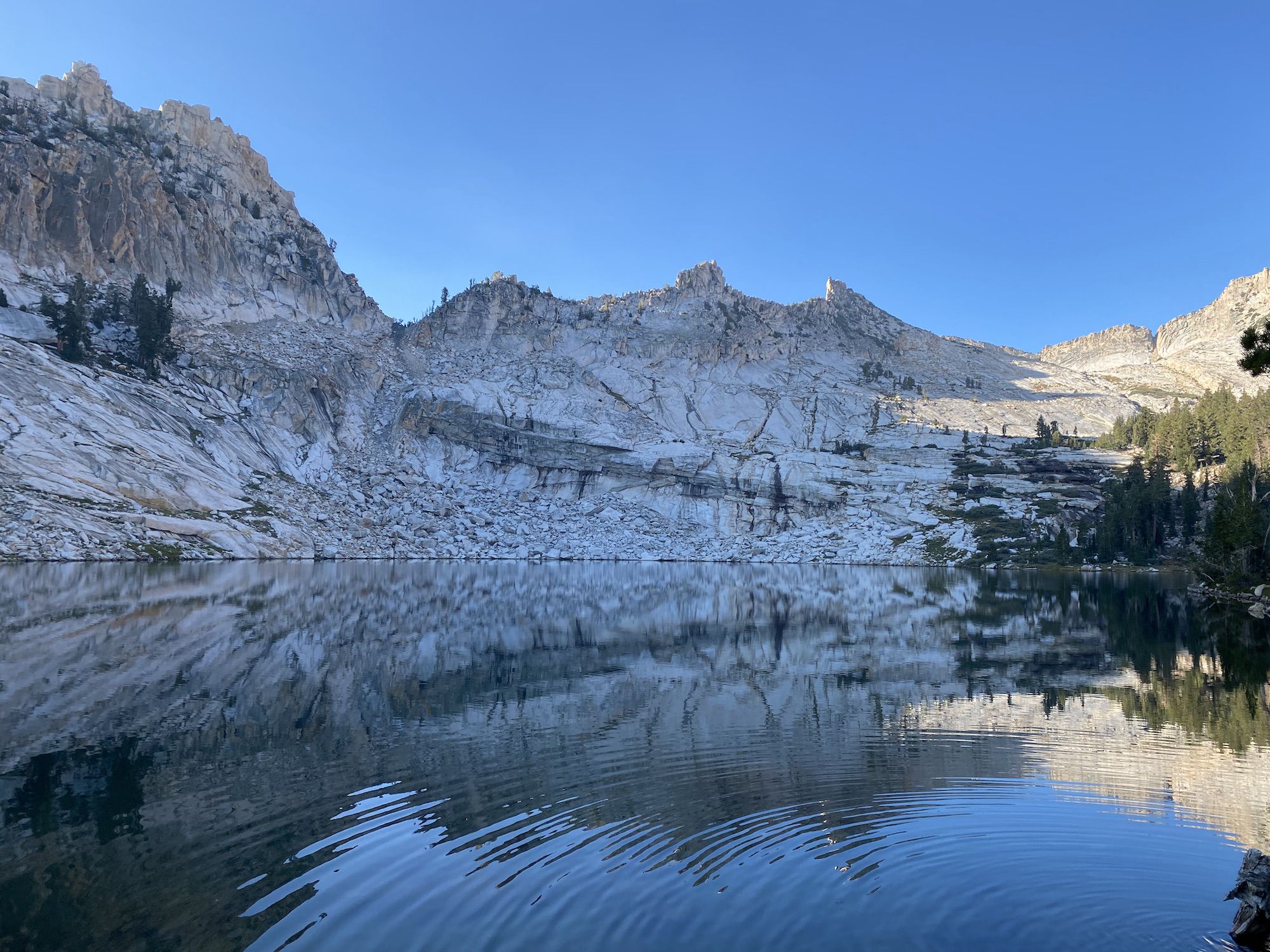 A mountain range partially lit by sunlight.