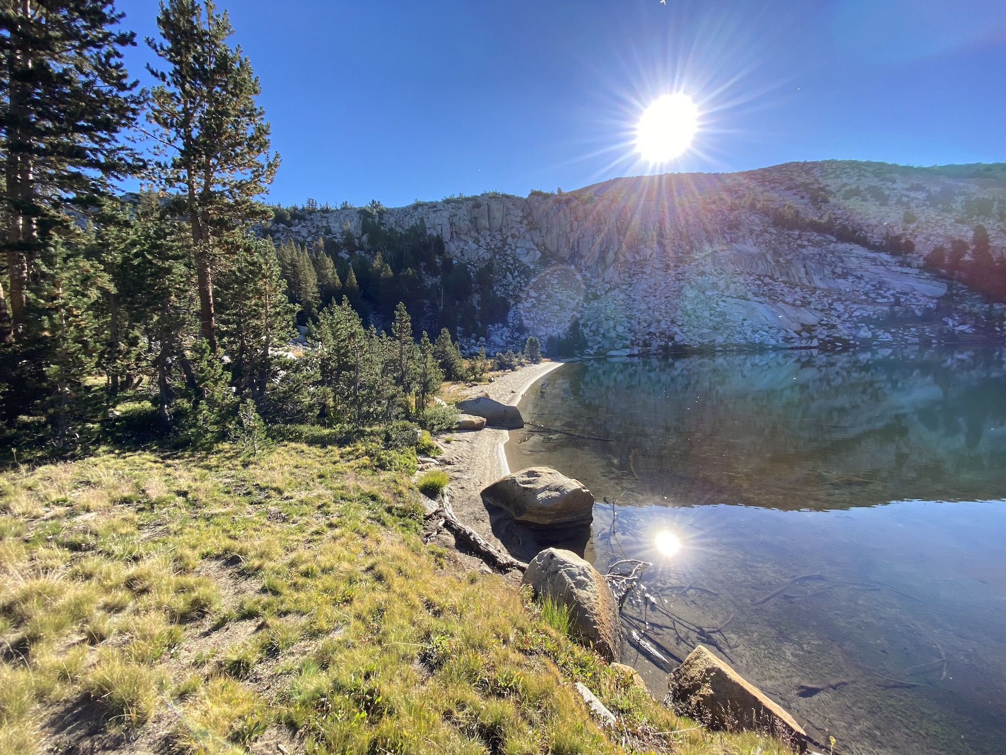 A calm lake reflecting the morning sun.