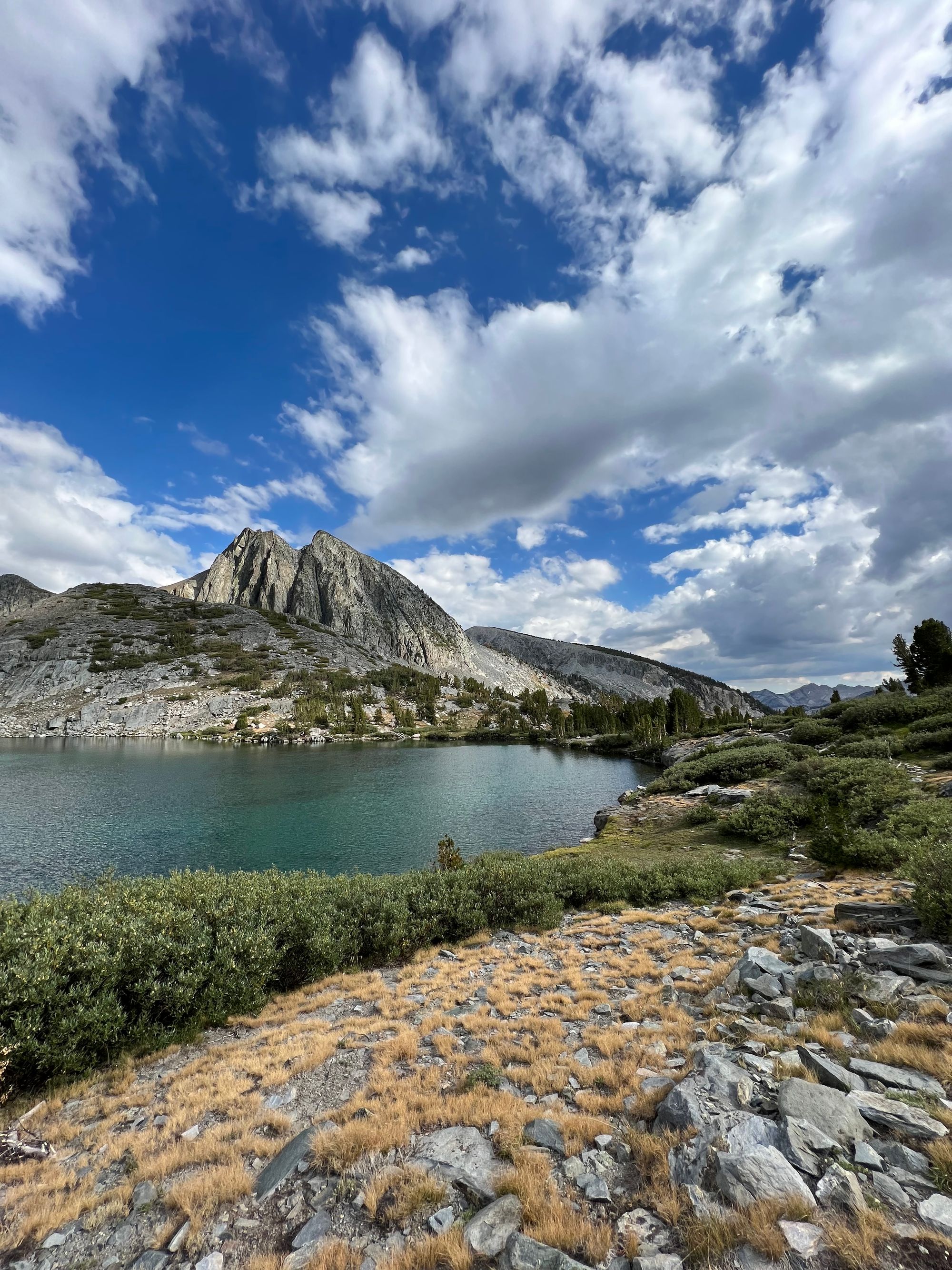 A mountain with two peaks behind a lake.