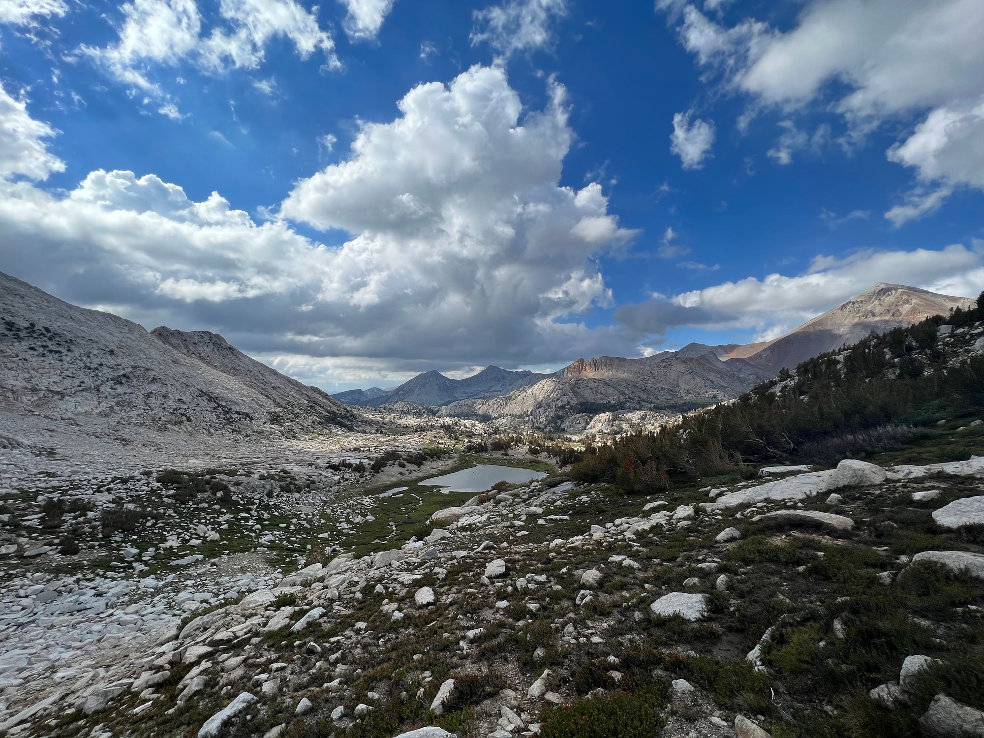 A small lake nested between mountains. 