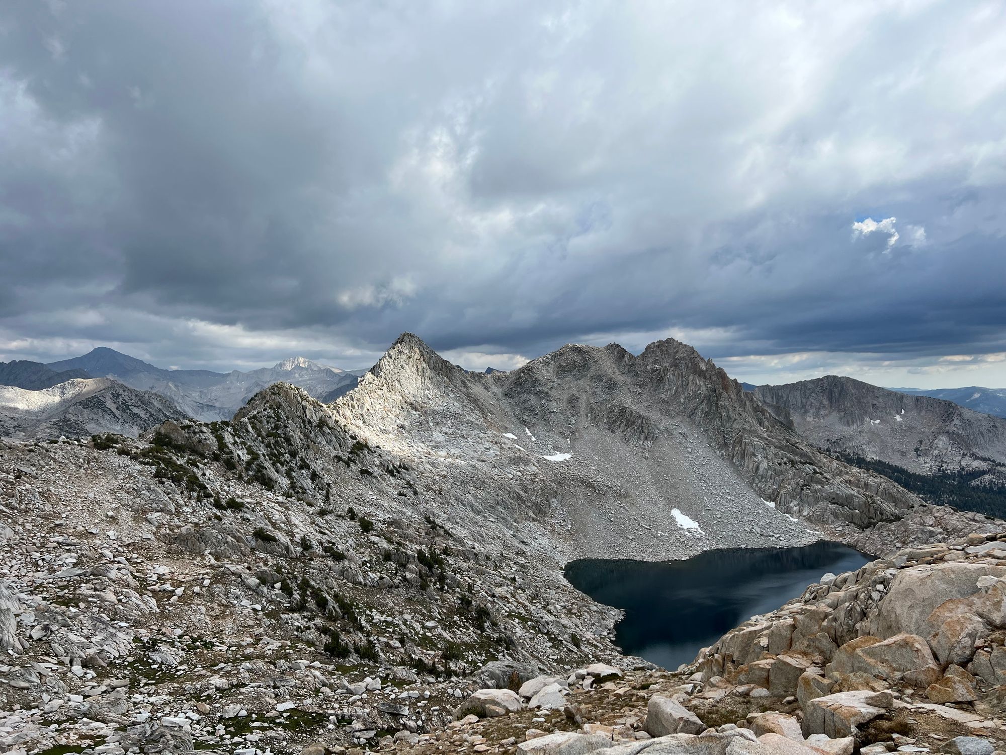 A deep-blue lake with a steep talus shore