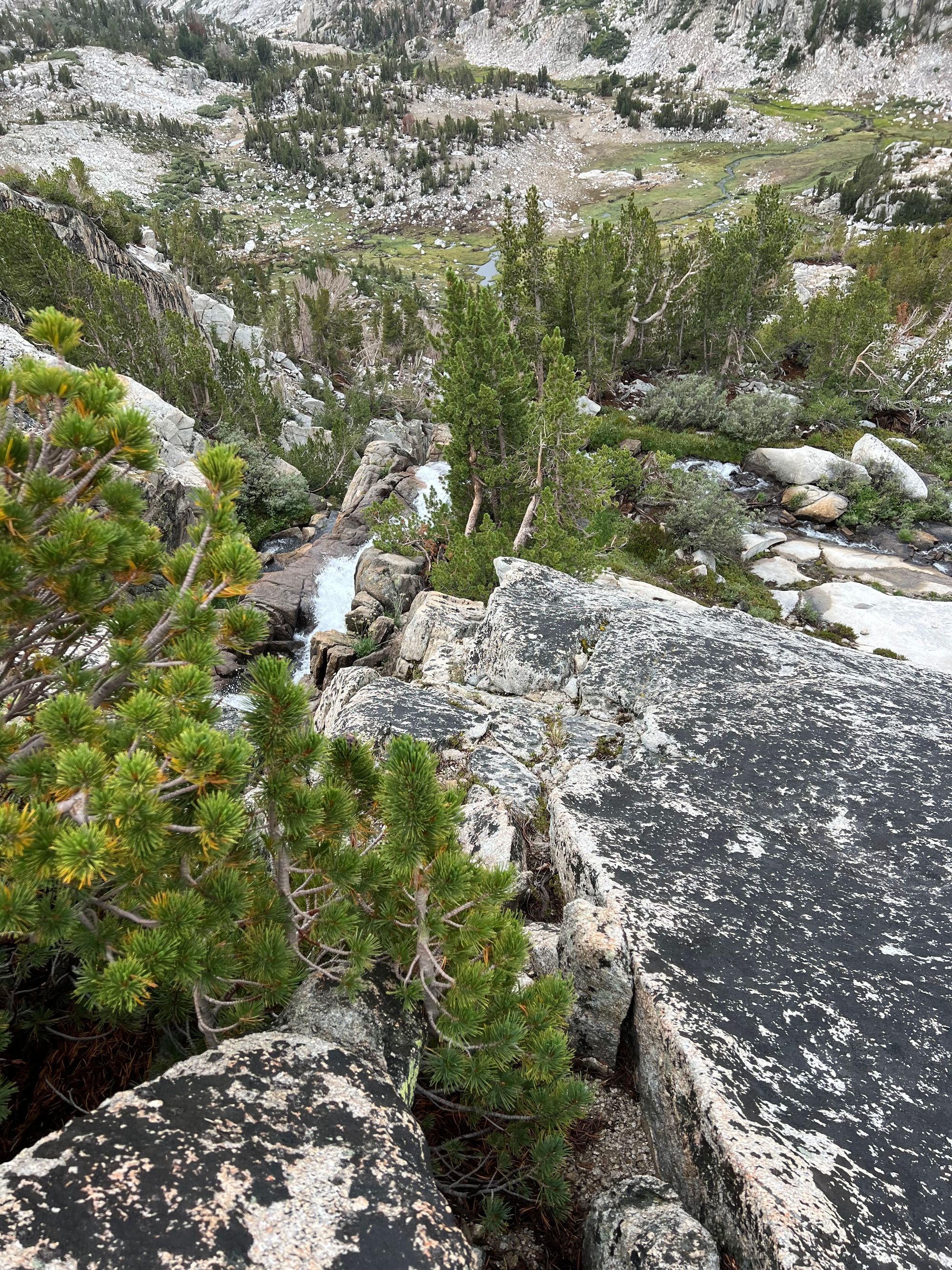 A seam in a granite slab next to a creek.