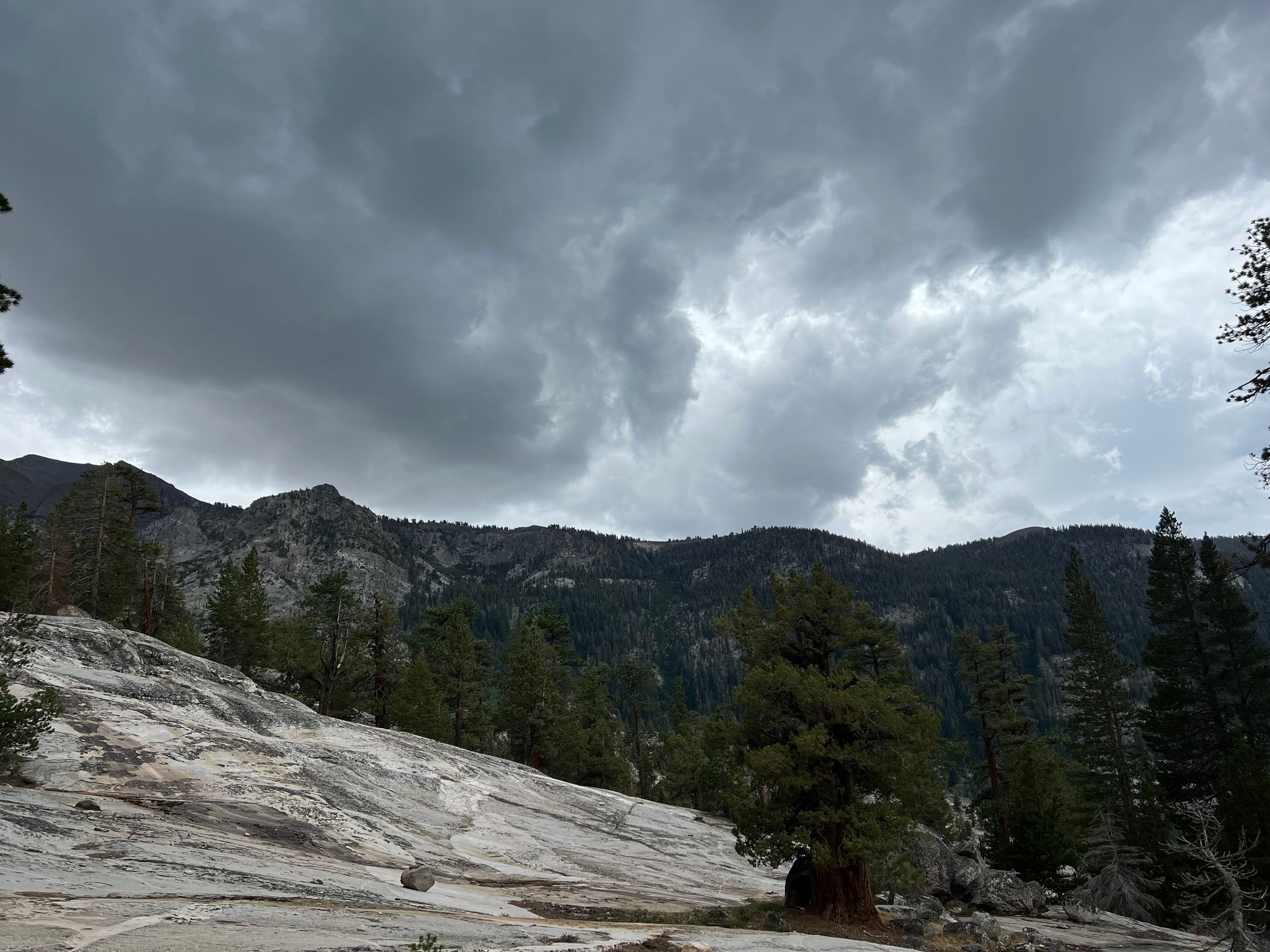Dark thunderclouds over a mountain ridge