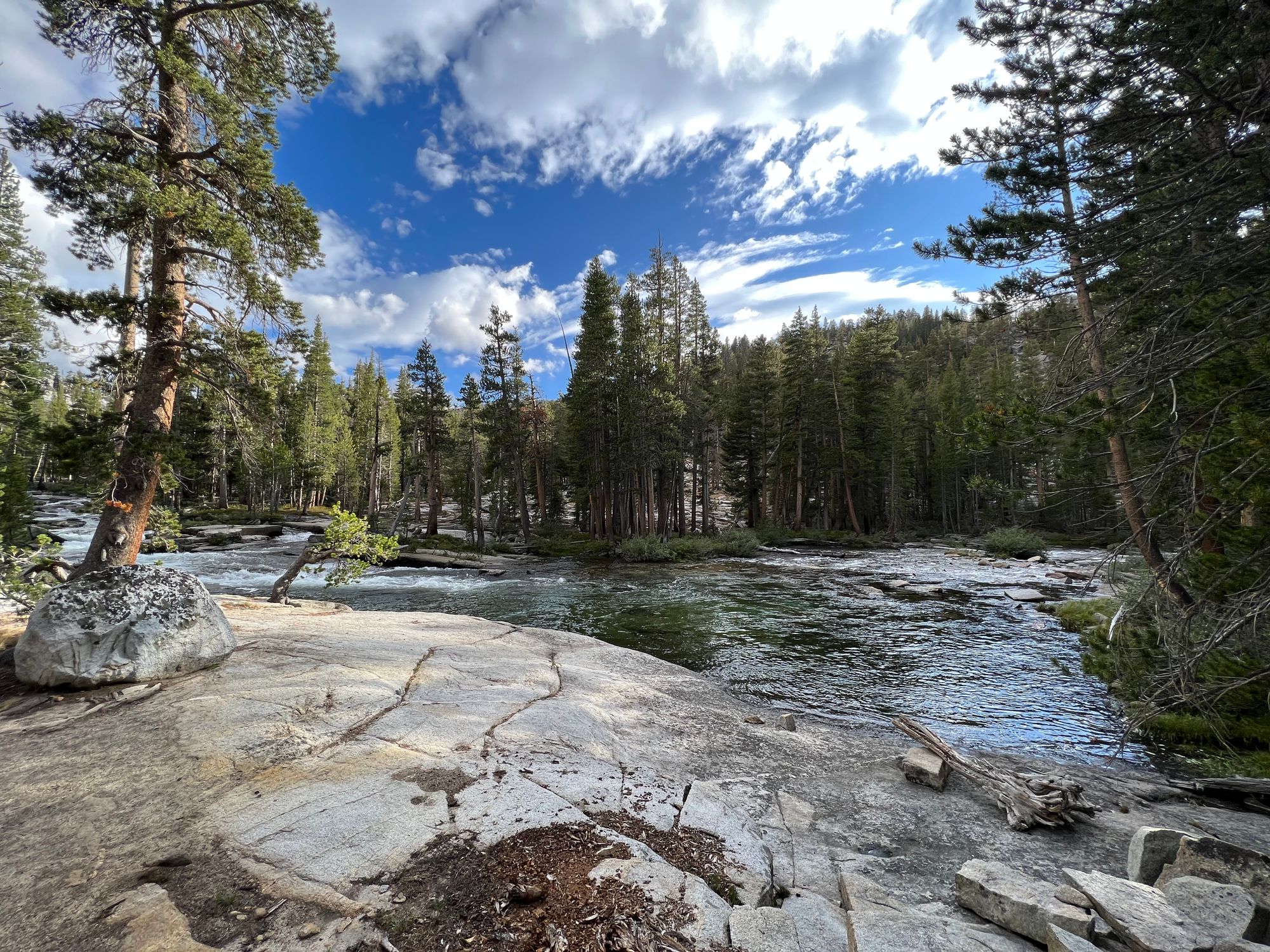 A deep turquoise pool in a creek bend.